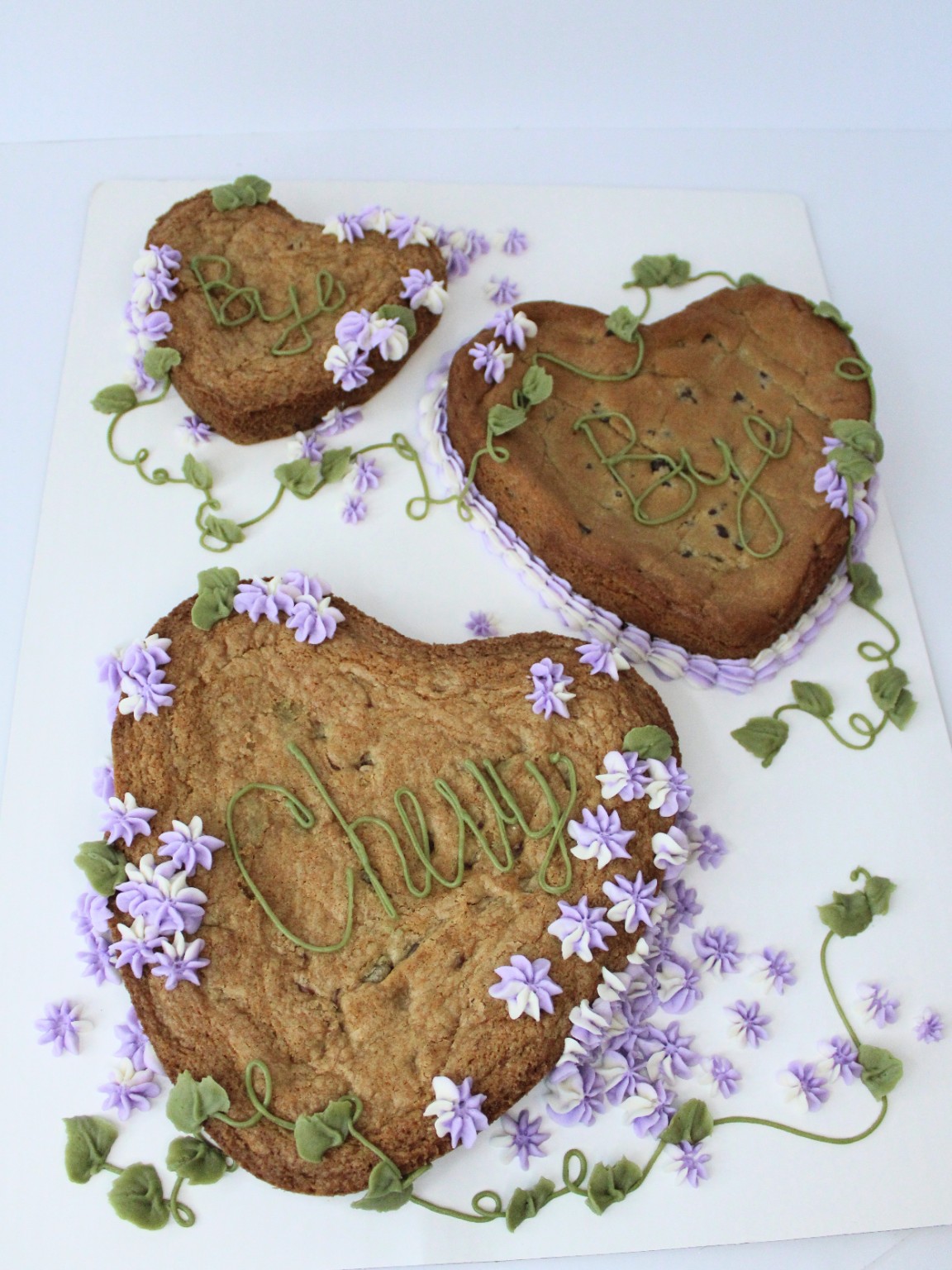 Heart-shaped cookie cakes with purple flowers